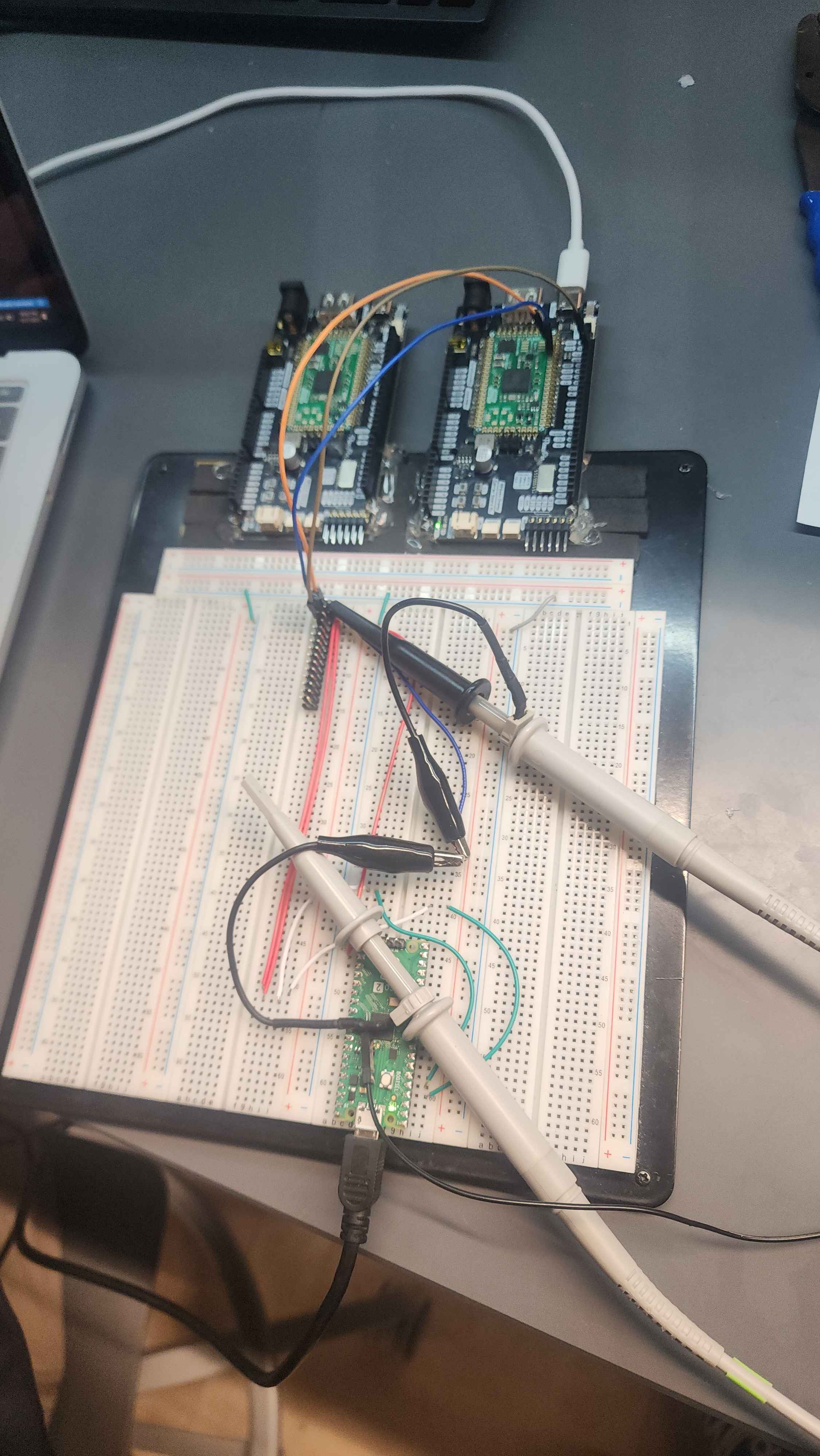 a prototype breadboard with two stamp carriers and a pico mounted on it